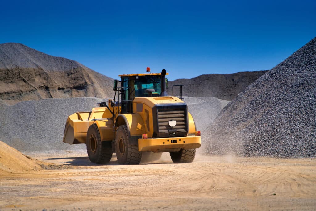 Heavy duty machinery working on highway construction site. Bulldozer, dumper truck, tractor.